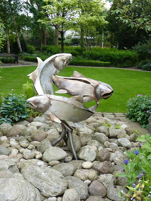 a fish statue in a park